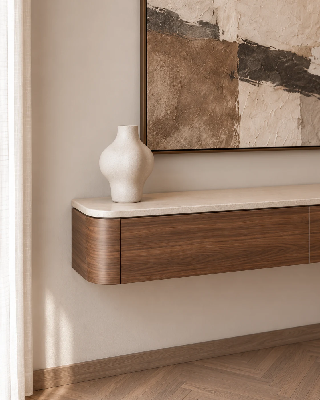 Rounded walnut console, pale stone top, ceramic vase and textured artwork