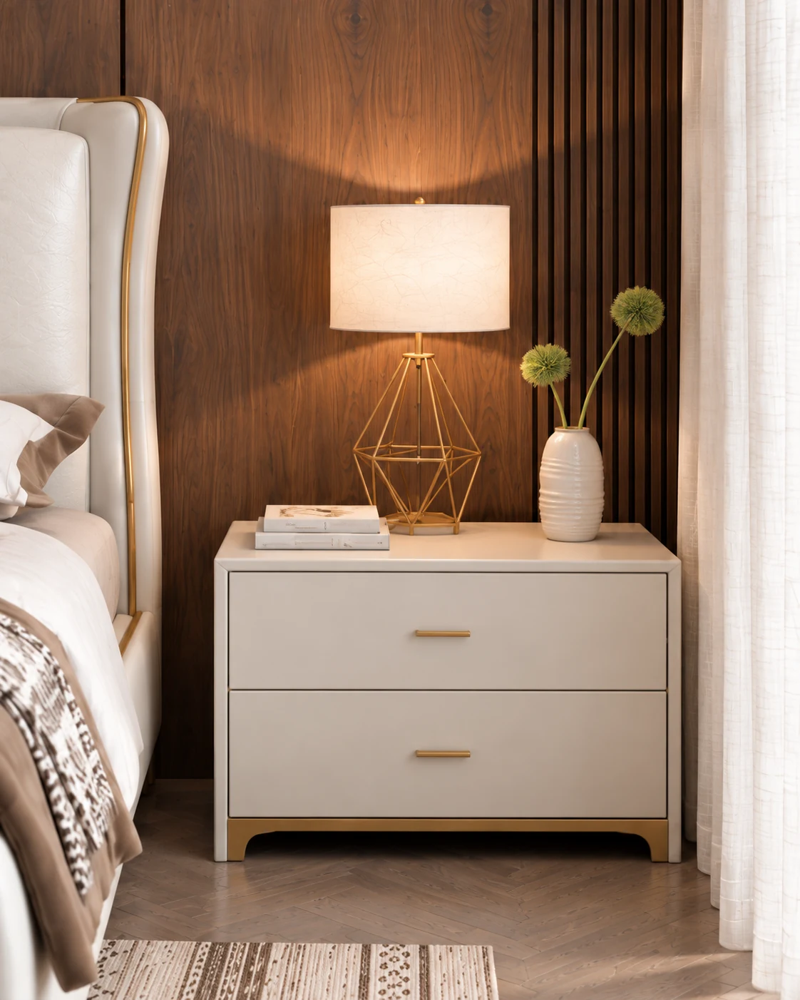 Brass geometric lamp and ivory bedside cabinet against walnut paneling