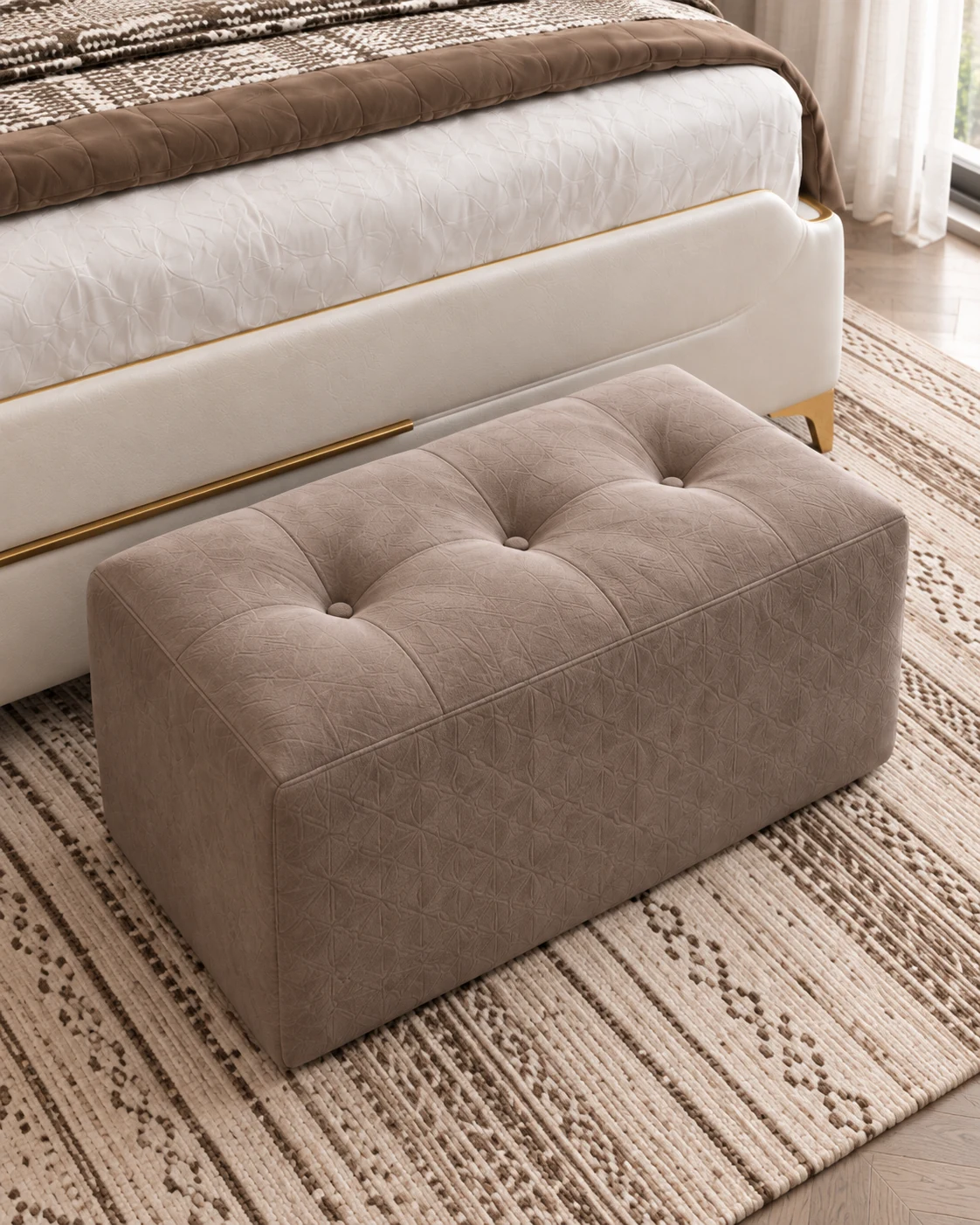 Taupe tufted ottoman on a cream and brown woven rug